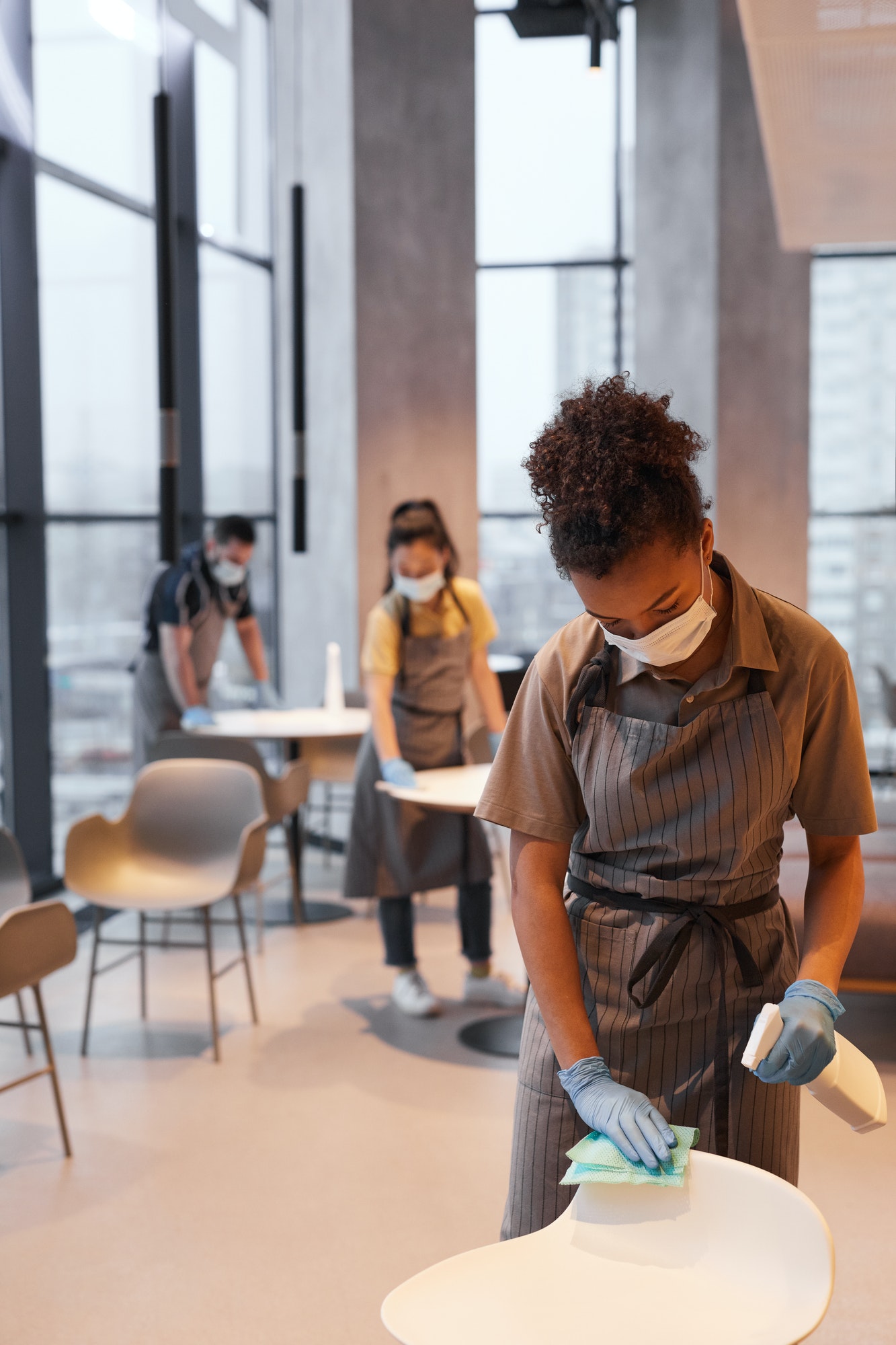 Young Woman Cleaning Cafe